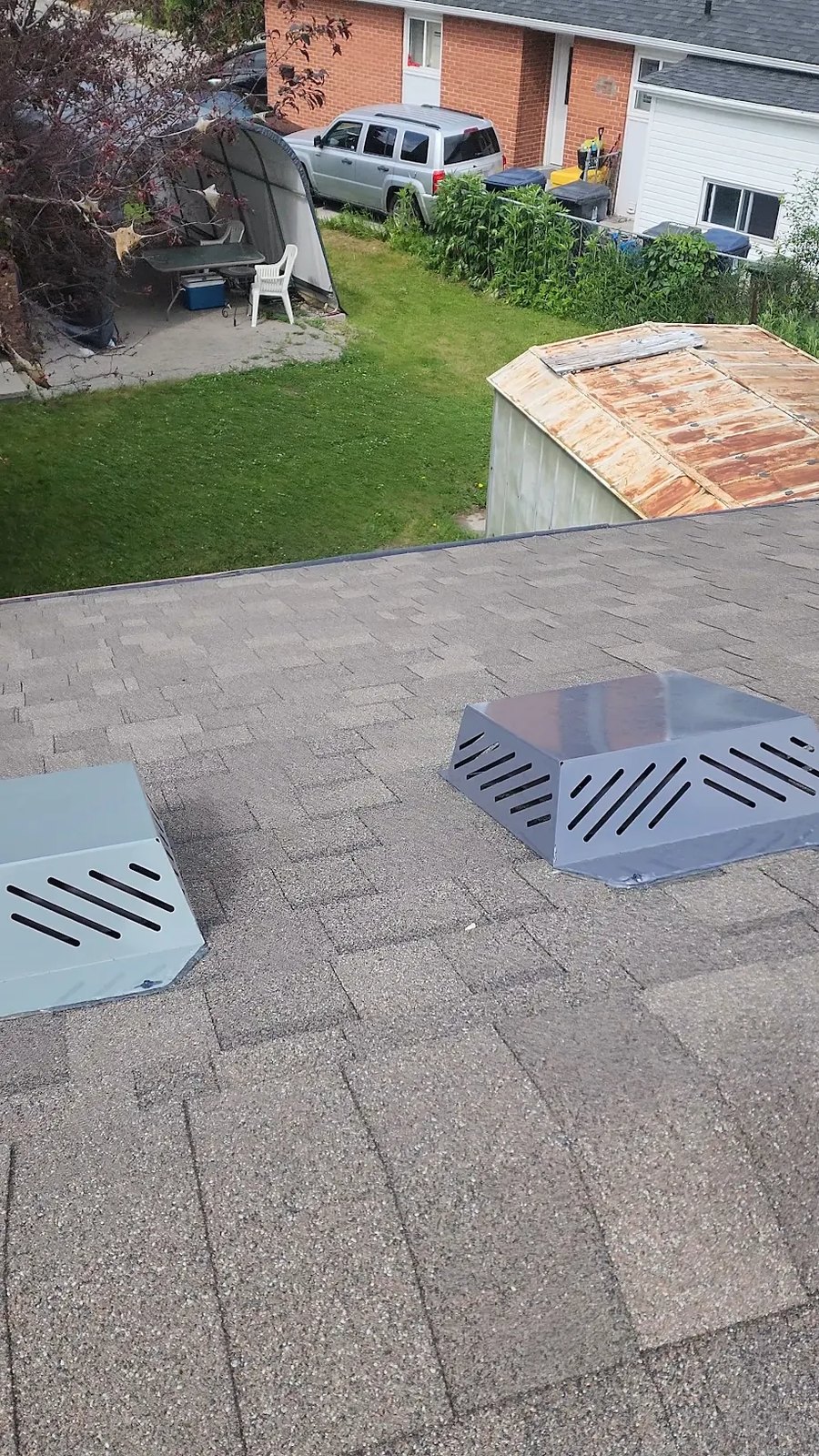 Two new box vents installed on a low-slope shingle roof in London, Ontario