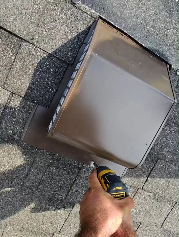 Installing a new metal box roof vent on an asphalt shingle roof in London, Ontario