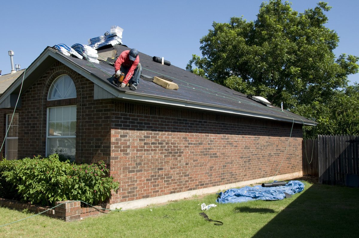 Roofer performing 24/7 emergency commercial roof repair in London, Ontario