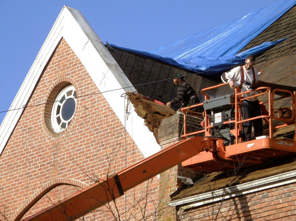 Roofers installing a new commercial roof in London, Ontario