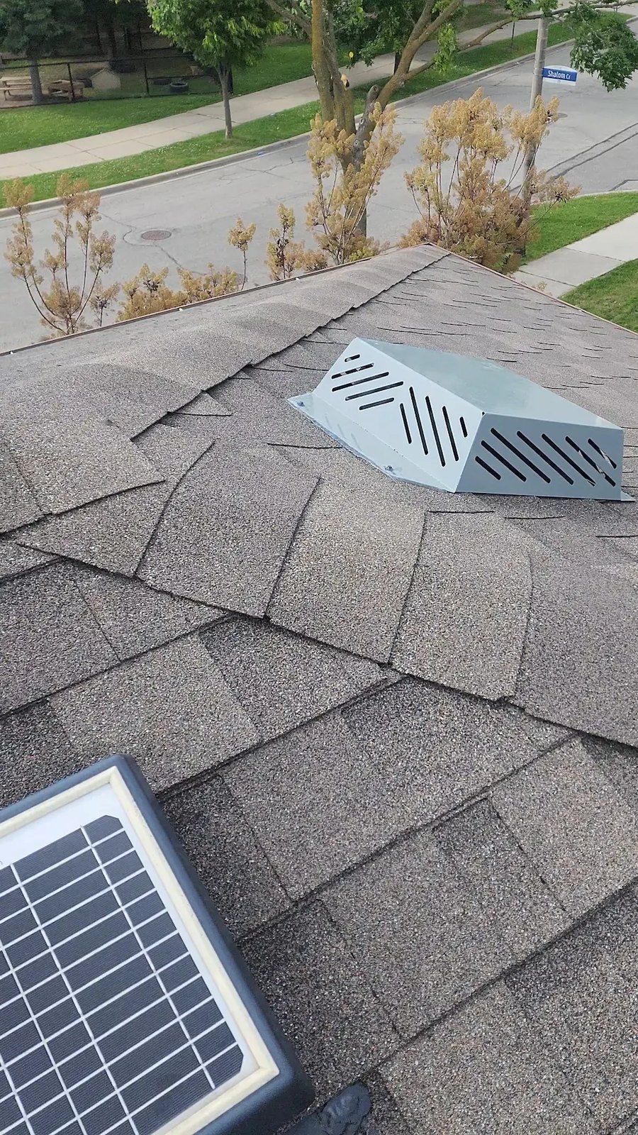 New box vent and solar-powered attic fan on a residential roof in London, Ontario