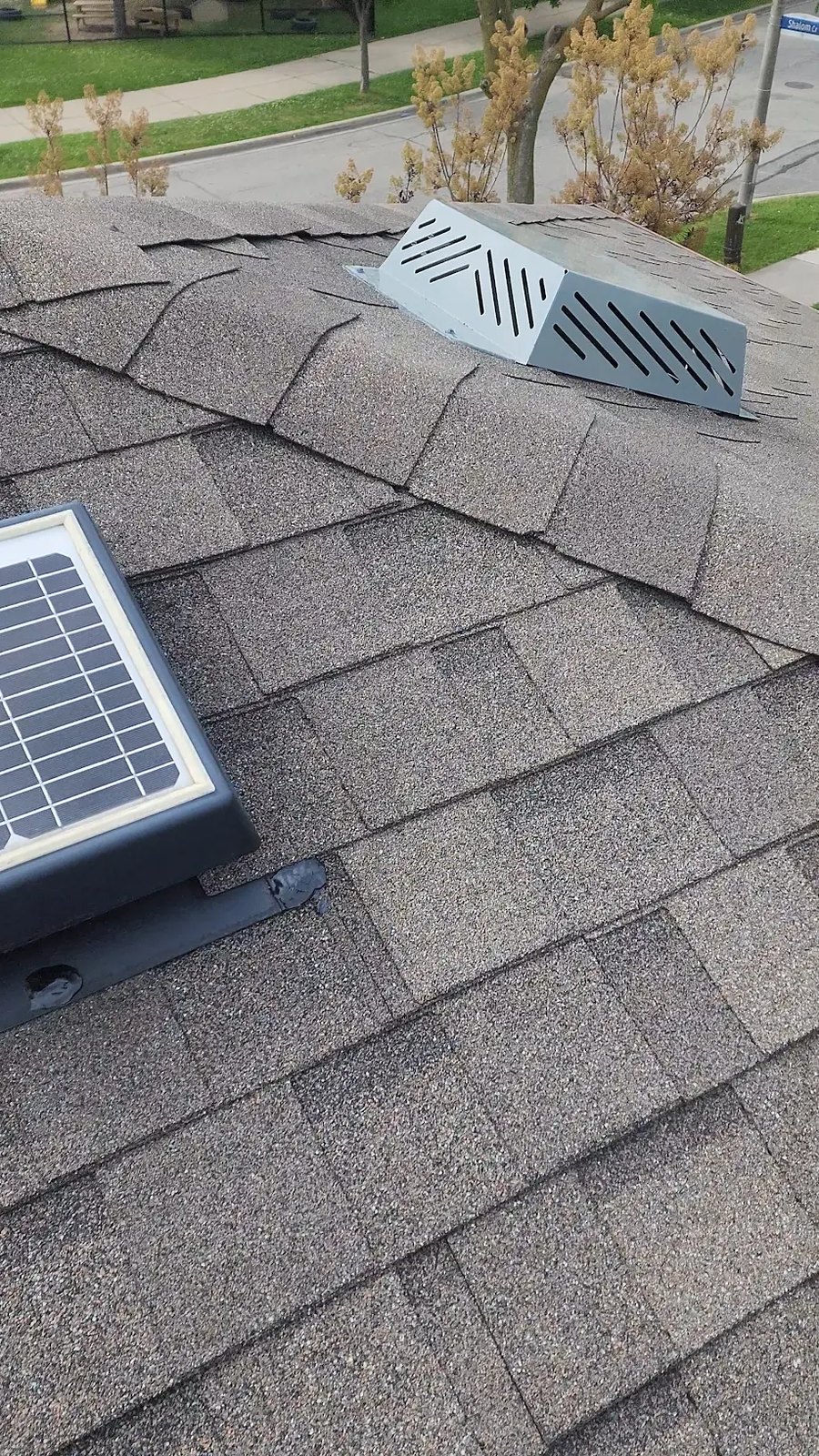 Solar-powered attic fan and box vent on a residential roof in London, Ontario